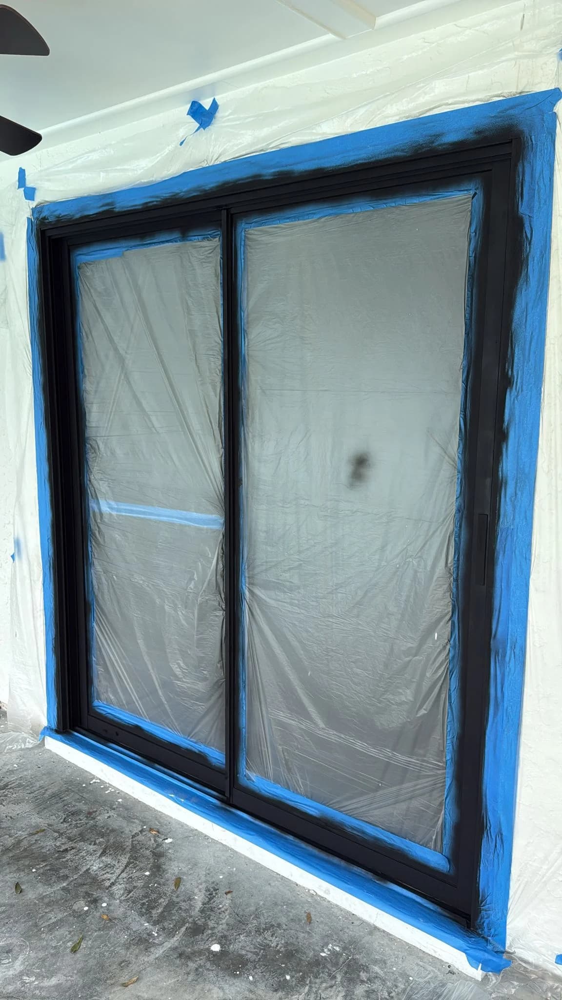 Black sliding glass door installation in progress — Central Florida home renovation